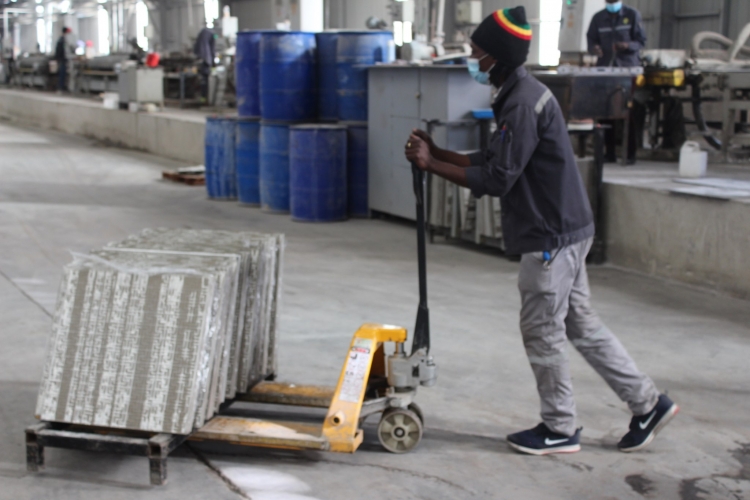 A Sunny Yi Feng Tile Zimbabwe employee working without adequate protective clothing